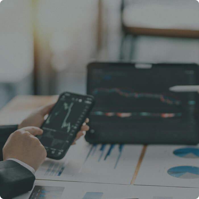 Wealth advisor reviewing financial market data on a smartphone