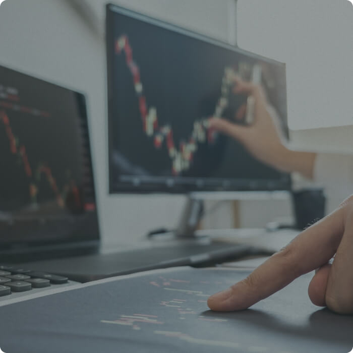 Investor analyzing stock market charts on a computer screen
